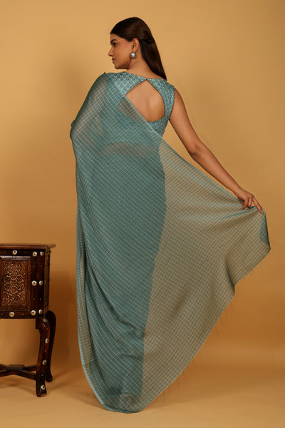 Sea green color tussar silk saree with silver strips.